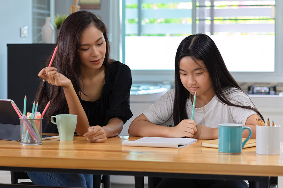 student and tutor together at a desk in Queens